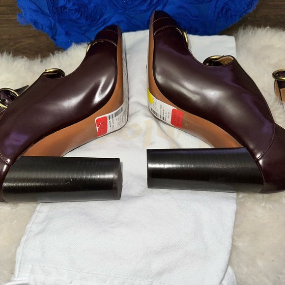 - [ ] Burgundy leather Chloé round-toe pumps with brass hardware, stacked heel - Picture 7 of 8